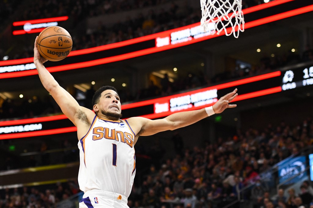  Devin Booker #1 of the Phoenix Suns dunks during the first half of a game against the Utah Jazz at Vivint Smart Home Arena on January 26, 2022 in Salt Lake City, Utah.