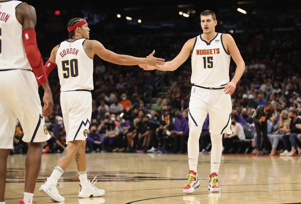 Nikola Jokic #15 of the Denver Nuggets high fives Aaron Gordon #50 during the first half of the 