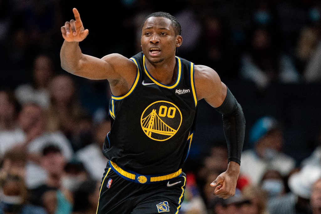 Jonathan Kuminga #00 of the Golden State Warriors reacts after making a basket against the Charlotte Hornets during the second quarter during their game at Spectrum Center on November 14, 2021 in Charlotte, North Carolina. 