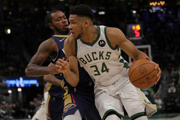 Giannis Antetokounmpo #34 of the Milwaukee Bucks is defended by 