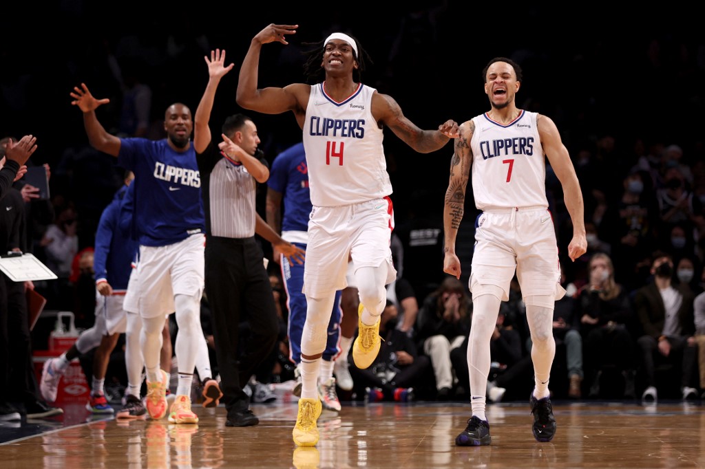Terance Mann #14 of the Los Angeles Clippers reacts after making a three point basket with Amir Coffey #7 of the Los Angeles Clippers during the fourth quarter against the Brooklyn Nets at Barclays Center on January 01, 2022 in New York City.