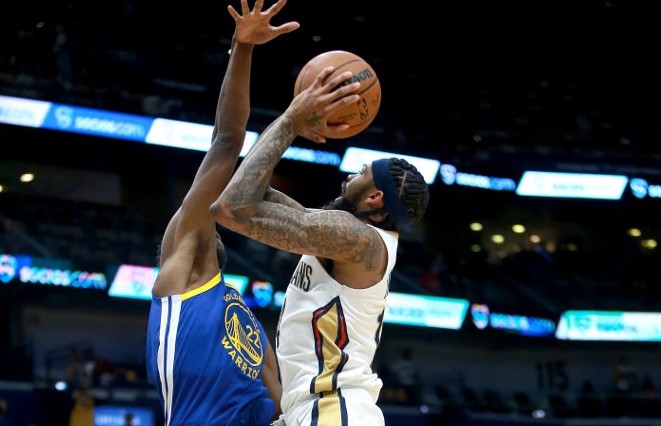 Brandon Ingram #14 of the New Orleans Pelicans shoots over Draymond Green #23 of the Golden State Warriors during the first quarter of a NBA game at Smoothie King Center on January 06, 2022 in New Orleans, Louisiana. 
