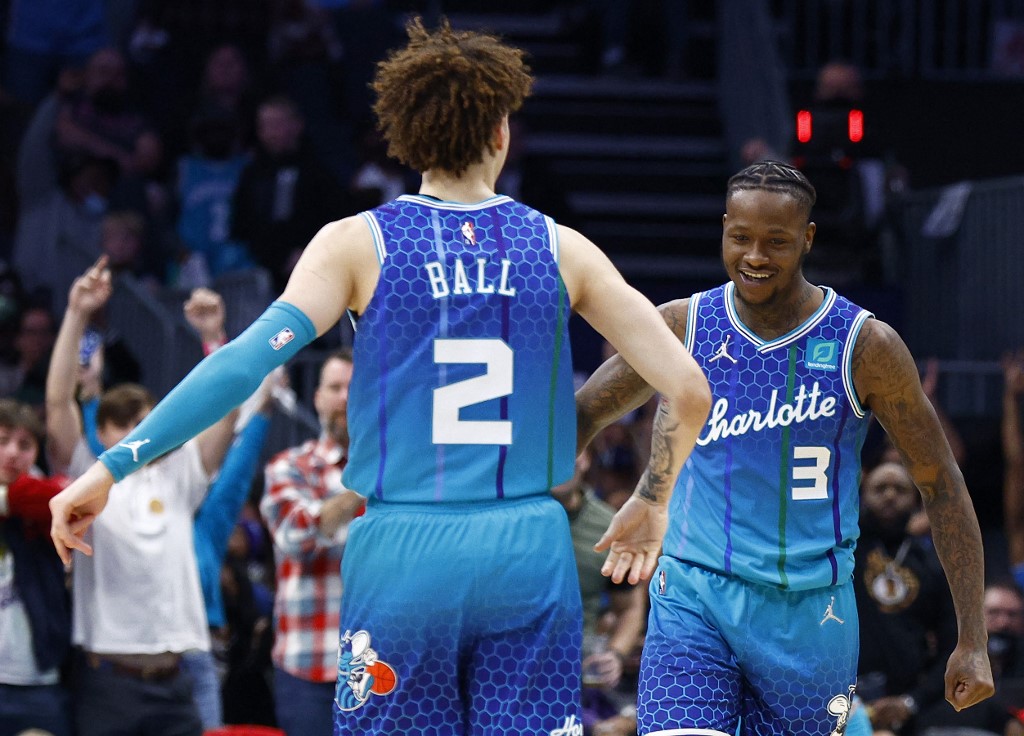 Terry Rozier #3 of the Charlotte Hornets celebrates with teammate LaMelo Ball #2 following a three point basket late in the fourth quarter of the game against the Milwaukee Bucks at Spectrum Center on January 08, 2022 in Charlotte, North Carolina.