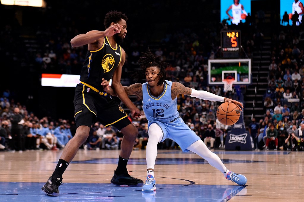  Ja Morant #12 of the Memphis Grizzlies goes to the basket against Andrew Wiggins #22 of the Golden State Warriors during the second half at FedExForum on January 11, 2022 in Memphis, Tennessee.