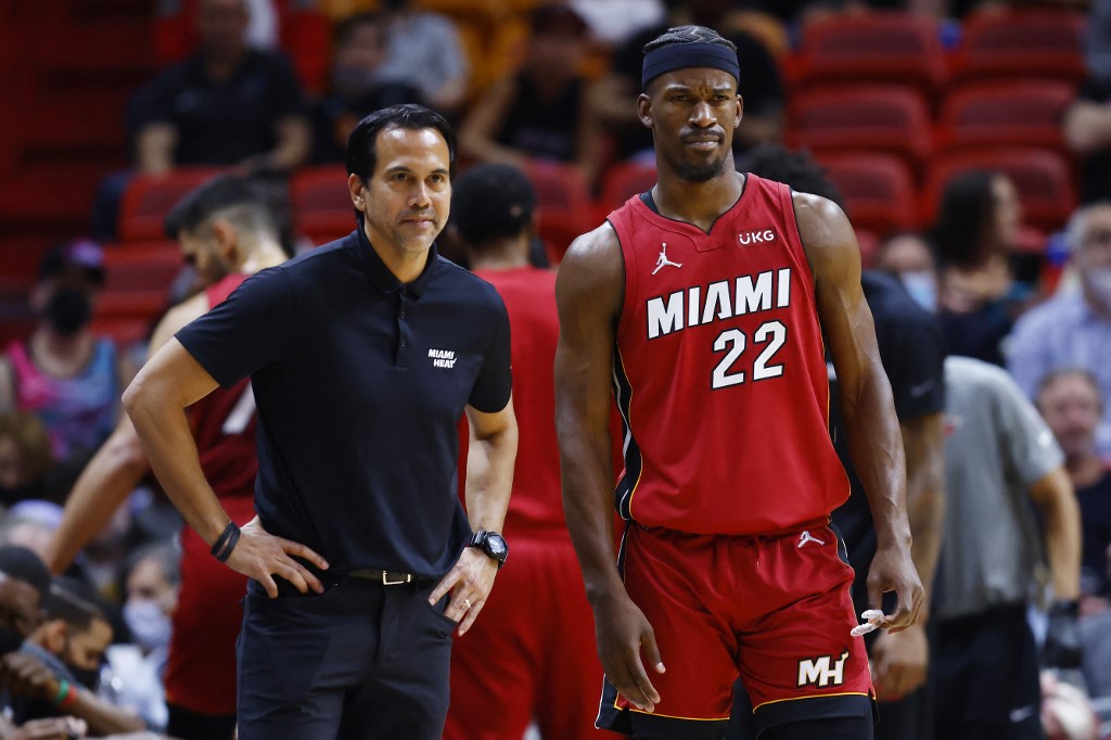 Head coach Erik Spoelstra and Jimmy Butler #22 of the Miami Heat look on against the Philadelphia 76ers during the first half at FTX Arena on January 15, 2022 in Miami, Florida.