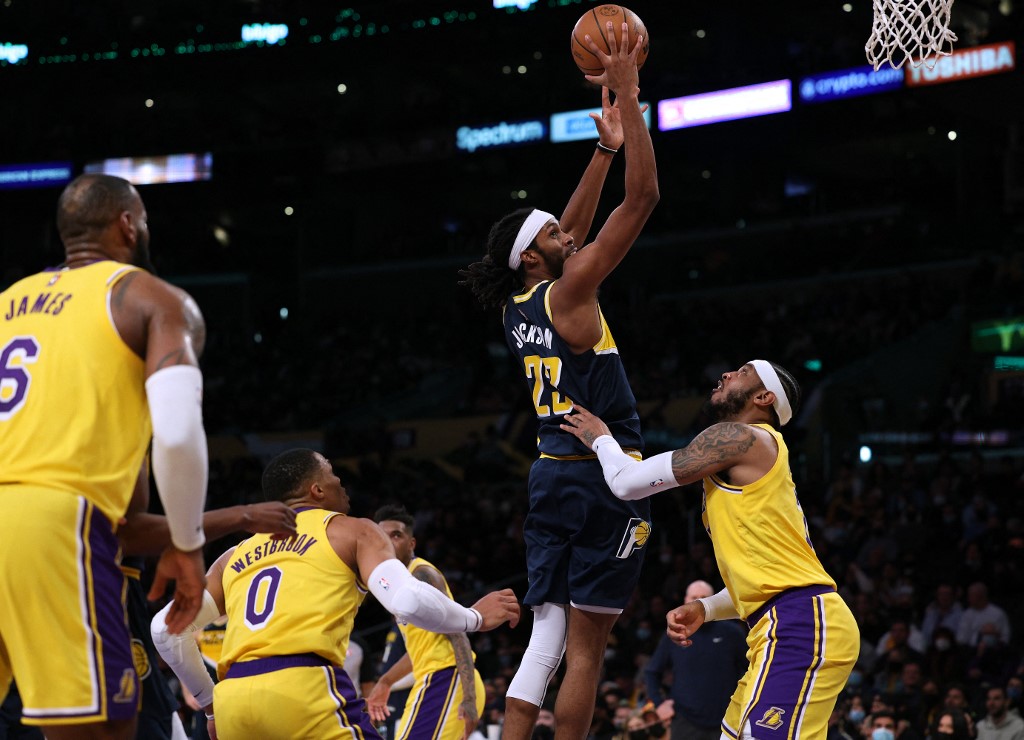 Caris LeVert #22 of the Indiana Pacers attempts a shot in front of Carmelo Anthony #7 and Russell Westbrook #0 of the Los Angeles Lakers during the first half at Crypto.com Arena on January 19, 2022 in Los Angeles, California. 