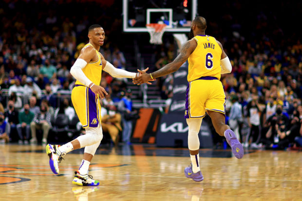 Russell Westbrook #0 and LeBron James #6 of the Los Angeles Lakers high five during a game against the Orlando Magic at Amway Center on January 21, 2022 in Orlando, Florida. NOTE TO USER: User expressly acknowledges and agrees that, by downloading and or using this photograph, User is consenting to the terms and conditions of the Getty Images License Agreement. Mike Ehrmann/Getty Images/AFP (Photo by Mike Ehrmann / GETTY IMAGES NORTH AMERICA / Getty Images via AFP)