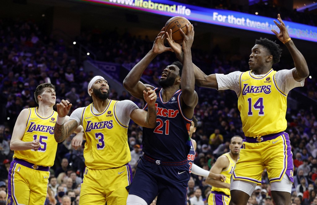  Joel Embiid #21 of the Philadelphia 76ers looks to shoot against Anthony Davis #3 and Stanley Johnson #14 of the Los Angeles Lakers during the second quarter at Wells Fargo Center on January 27, 2022 in Philadelphia, Pennsylvania