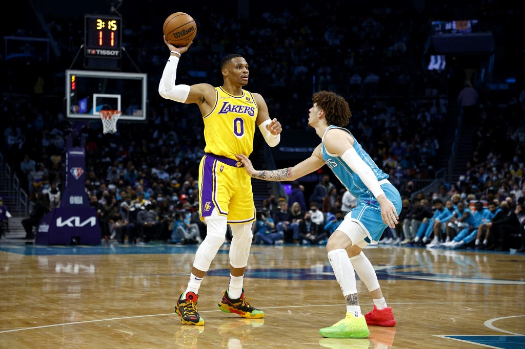  Russell Westbrook #0 of the Los Angeles Lakers looks over the court as he is guarded by LaMelo Ball #2 of the Charlotte Hornets during the first half of the game at Spectrum Center on January 28, 2022 in Charlotte, North Carolina. 