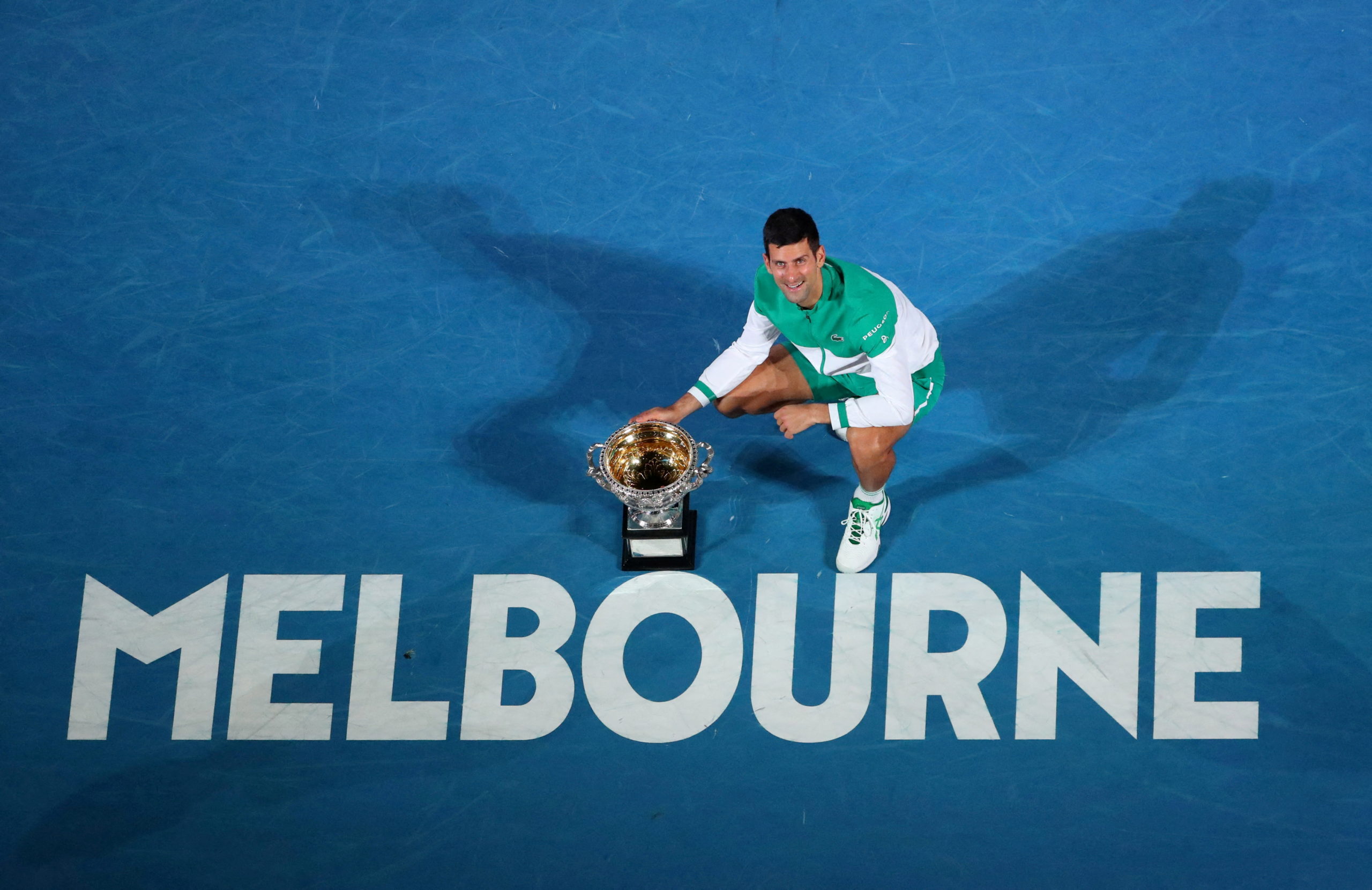 FILE PHOTO: Tennis - Australian Open - Men's Singles Final - Melbourne Park, Melbourne, Australia, February 21, 2021 Serbia's Novak Djokovic celebrates with the trophy after winning his final match against Russia's Daniil Medvedev REUTERS/Kelly Defina/File Photo