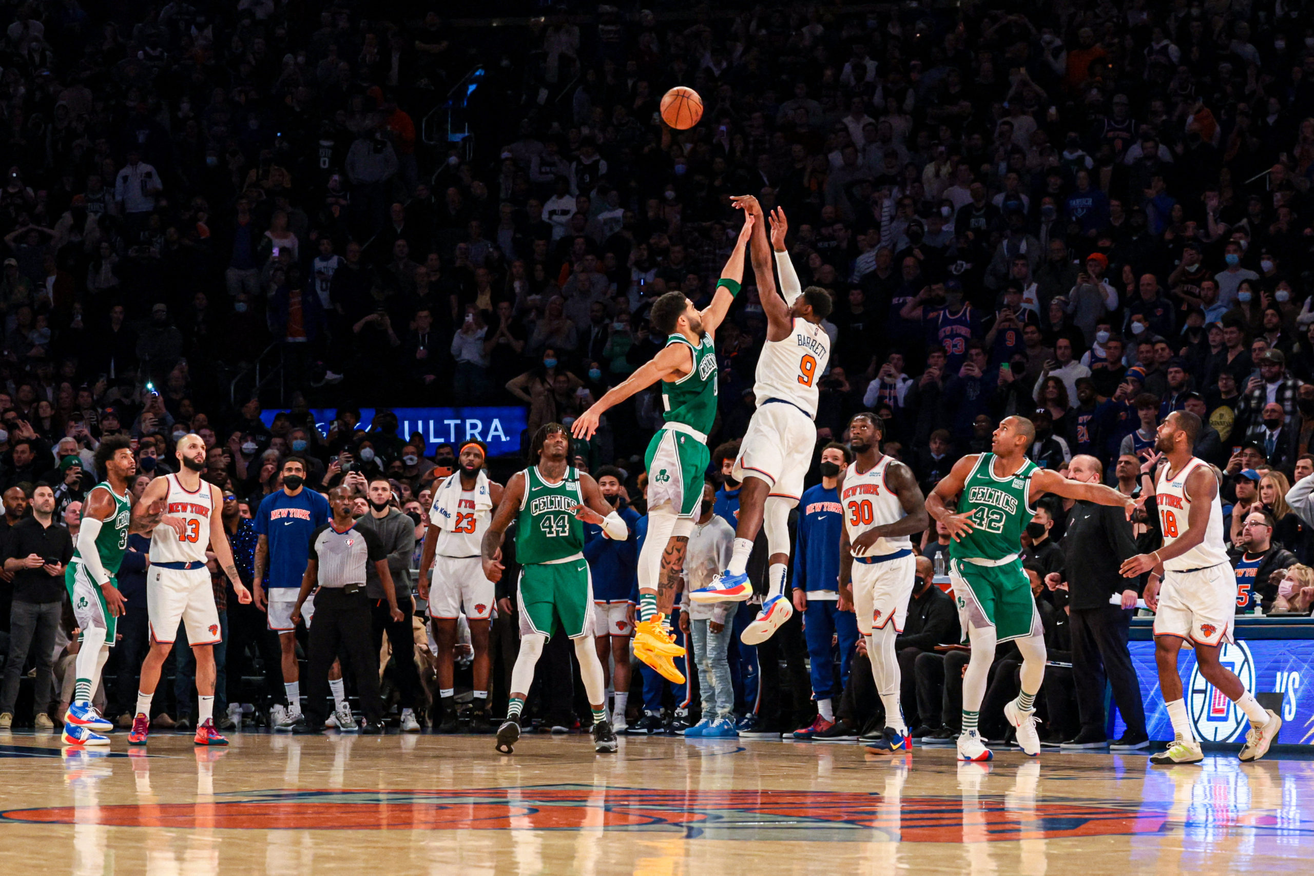  New York Knicks guard RJ Barrett (9) makes a game-winning three point basket during the fourth quarter as Boston Celtics forward Jayson Tatum (0) defends at Madison Square Garden. 