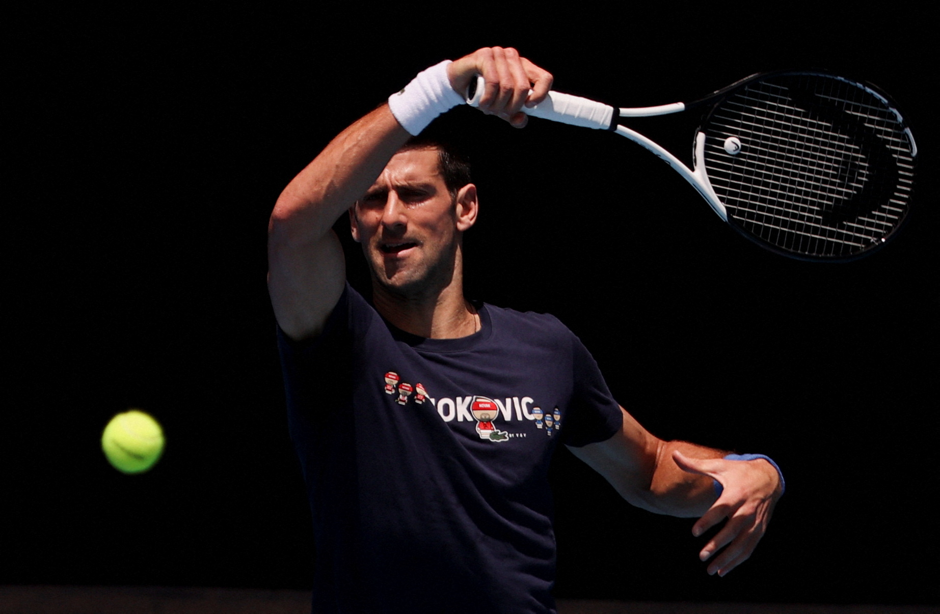 Serbian tennis player Novak Djokovic practices at Melbourne Park as questions remain over the legal battle regarding his visa to play in the Australian Open in Melbourne, Australia, January 12, 2022. 