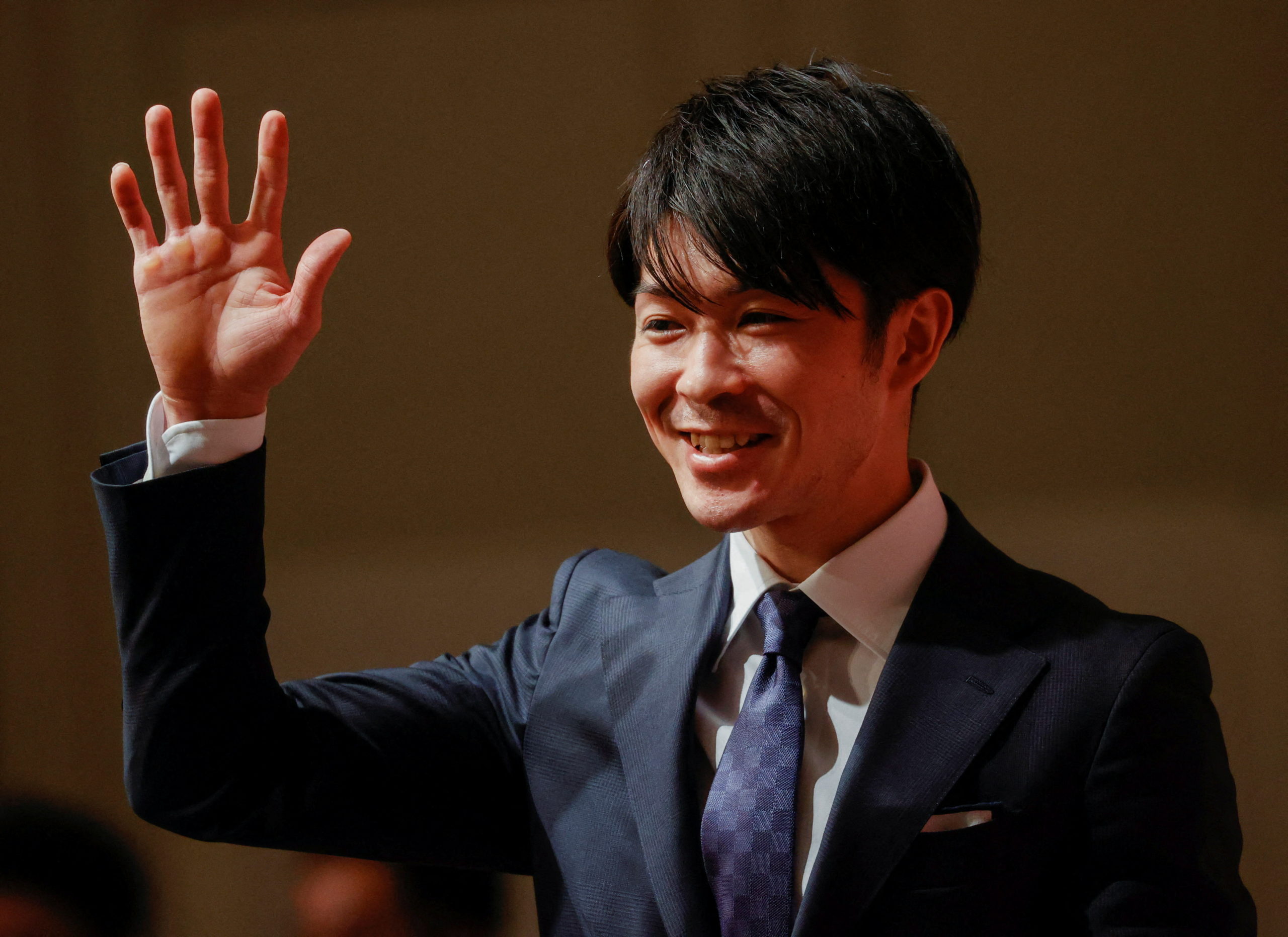 Japan's two-time Olympic all-around gymnastics champion Kohei Uchimura waves as he leaves a news conference on his retirement in Tokyo, Japan January 14, 2022