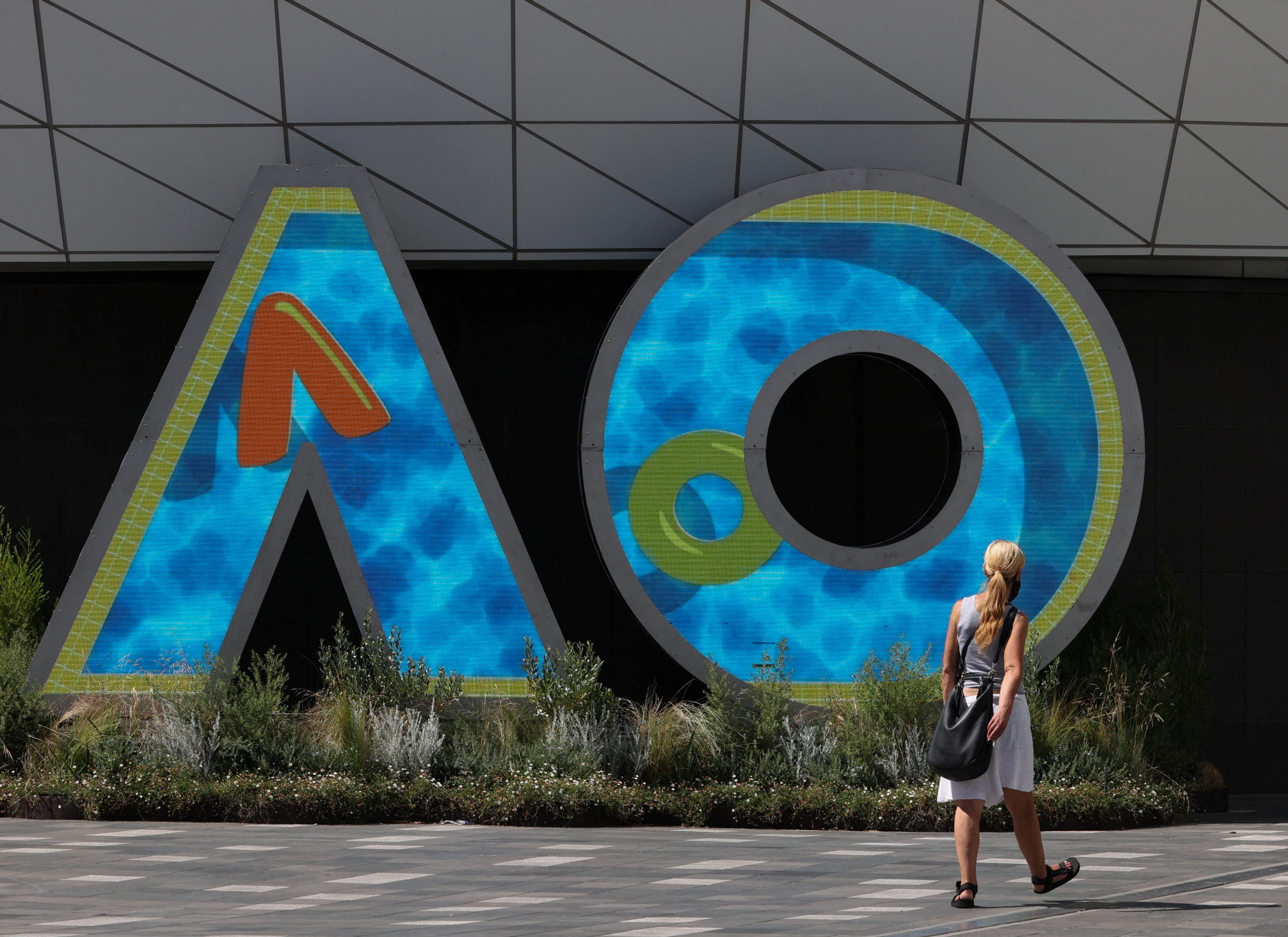A person walks through Melbourne Park in the lead-up to the Australian Open in Melbourne, Australia, January 12, 2022.