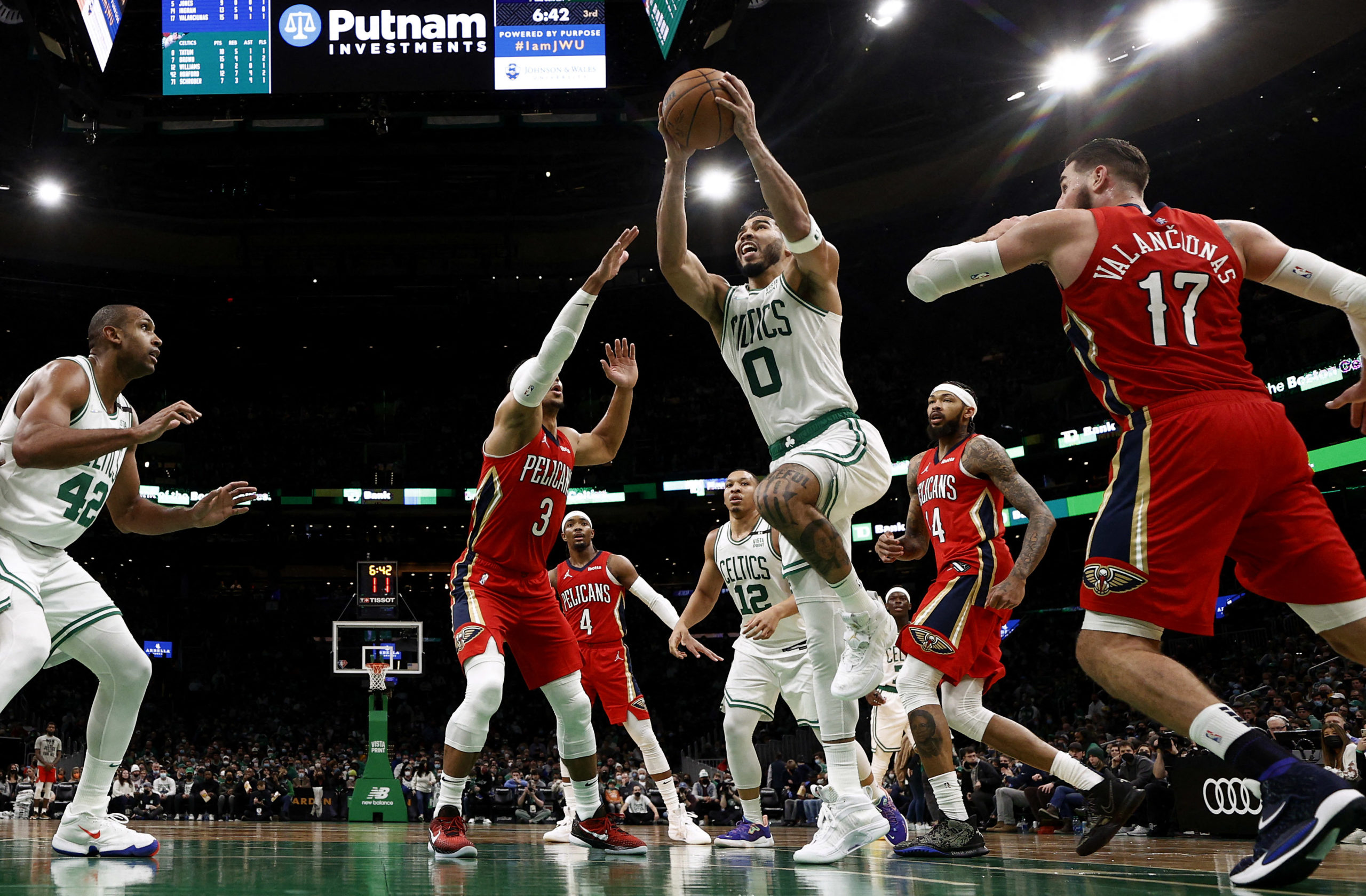 Boston Celtics forward Jayson Tatum (0) goes past New Orleans Pelicans center Jonas Valanciunas (17) during the second half at TD Garden