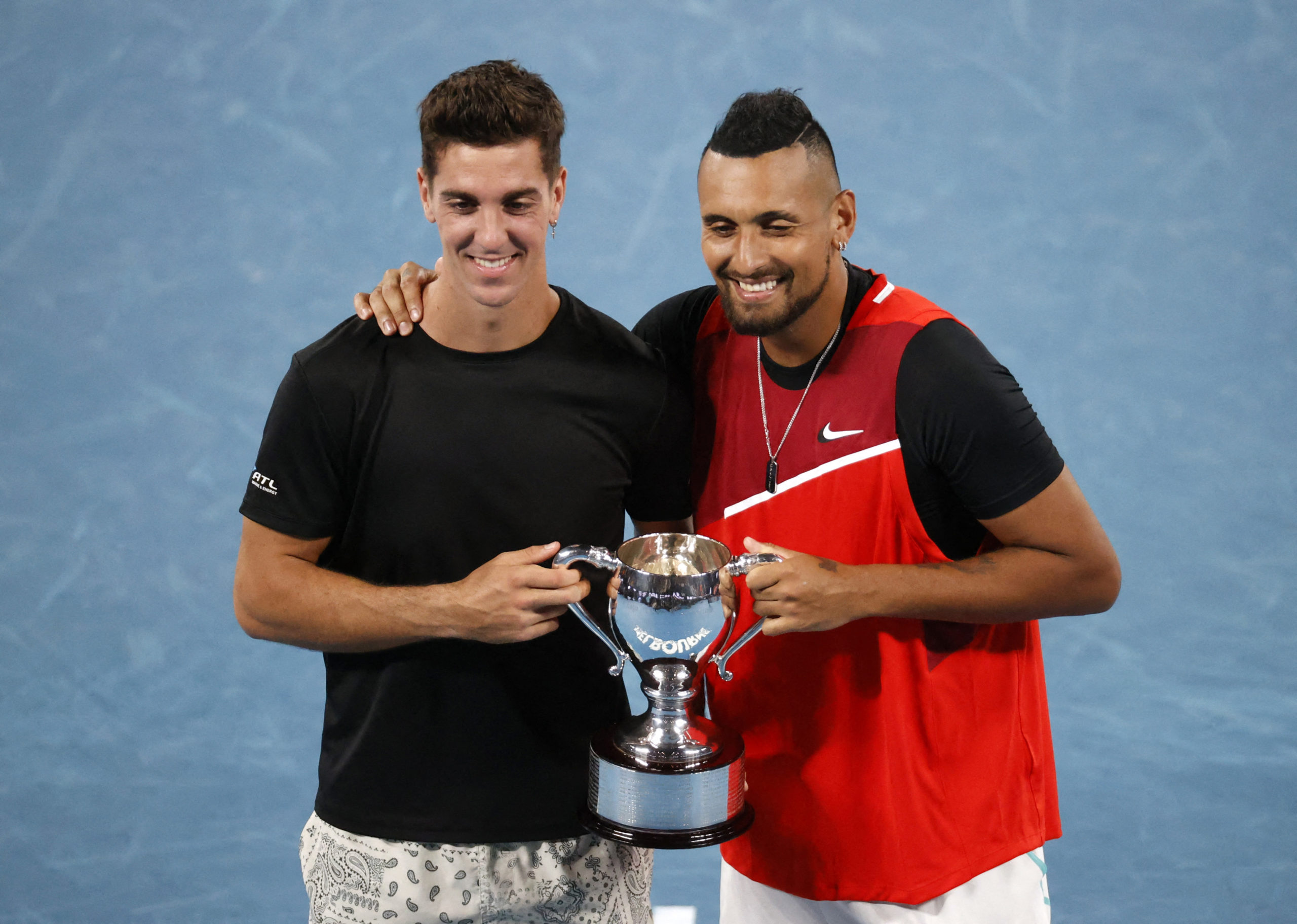 Tennis - Australian Open - Men's Doubles Final - Melbourne Park, Melbourne, Australia - January 29, 2022 Australia's Nick Kyrgios and Thanasi Kokkinakis celebrate winning the final against Australia's Matthew Ebden and Max Purcell with the trophy