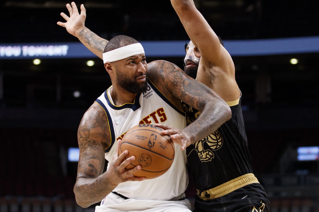 DeMarcus Cousins #4 of the Denver Nuggets drives to the basket against Khem Birch #24 of the Toronto Raptors during the first half of their NBA game at Scotiabank Arena on February 12, 2022 in Toronto, Canada.