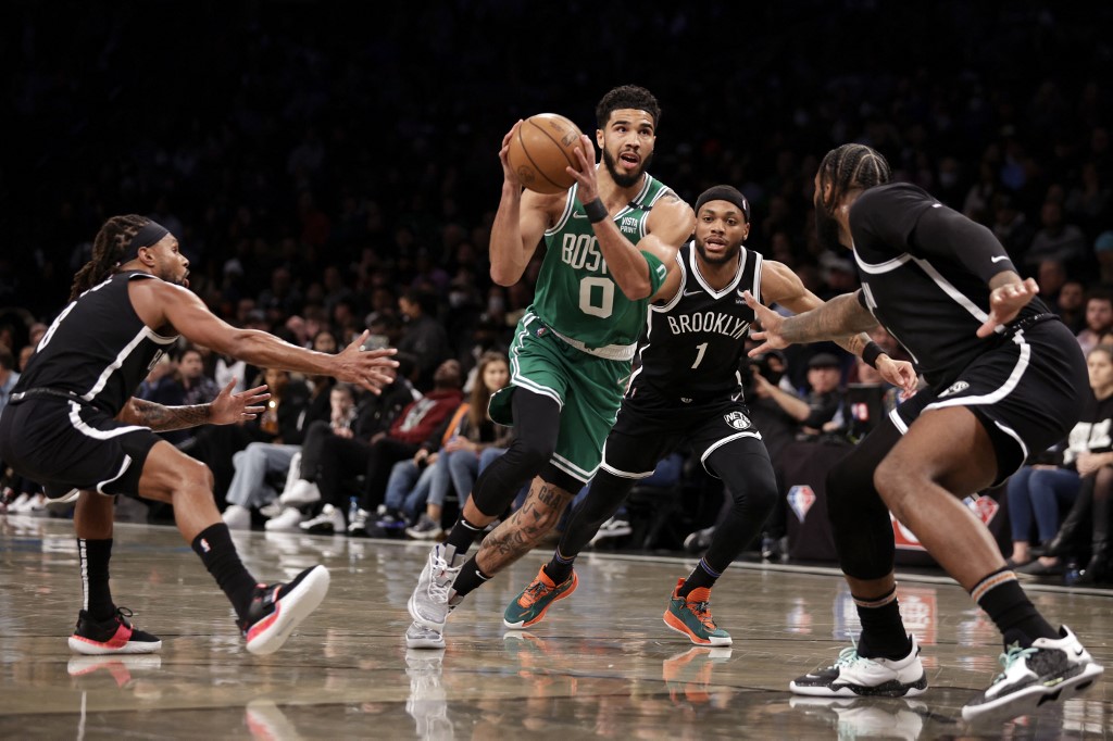 Jayson Tatum #0 of the Boston Celtics drives to the basket past Bruce Brown #1 of the Brooklyn Nets during the first half at Barclays Center on February 24, 2022 in New York City.