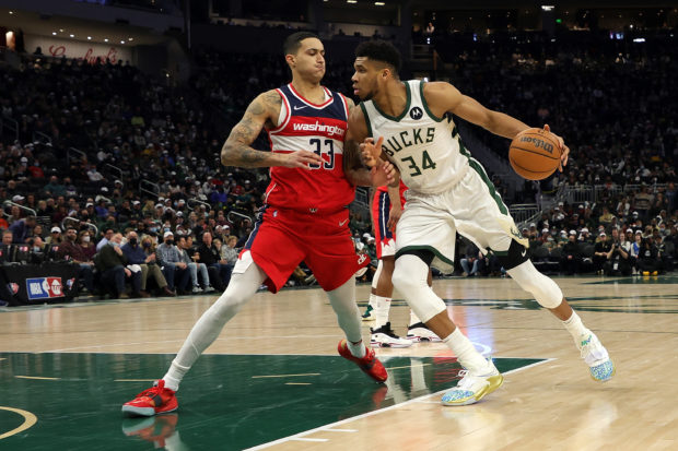 Giannis Antetokounmpo #34 of the Milwaukee Bucks is defended by Kyle Kuzma #33 of the Washington Wizards during the first half of a game at Fiserv Forum on February 01, 2022 in Milwaukee, Wisconsin. NOTE TO USER: User expressly acknowledges and agrees that, by downloading and or using this photograph, User is consenting to the terms and conditions of the Getty Images License Agreement. Stacy Revere/Getty Images/AFP (Photo by Stacy Revere / GETTY IMAGES NORTH AMERICA / Getty Images via AFP)