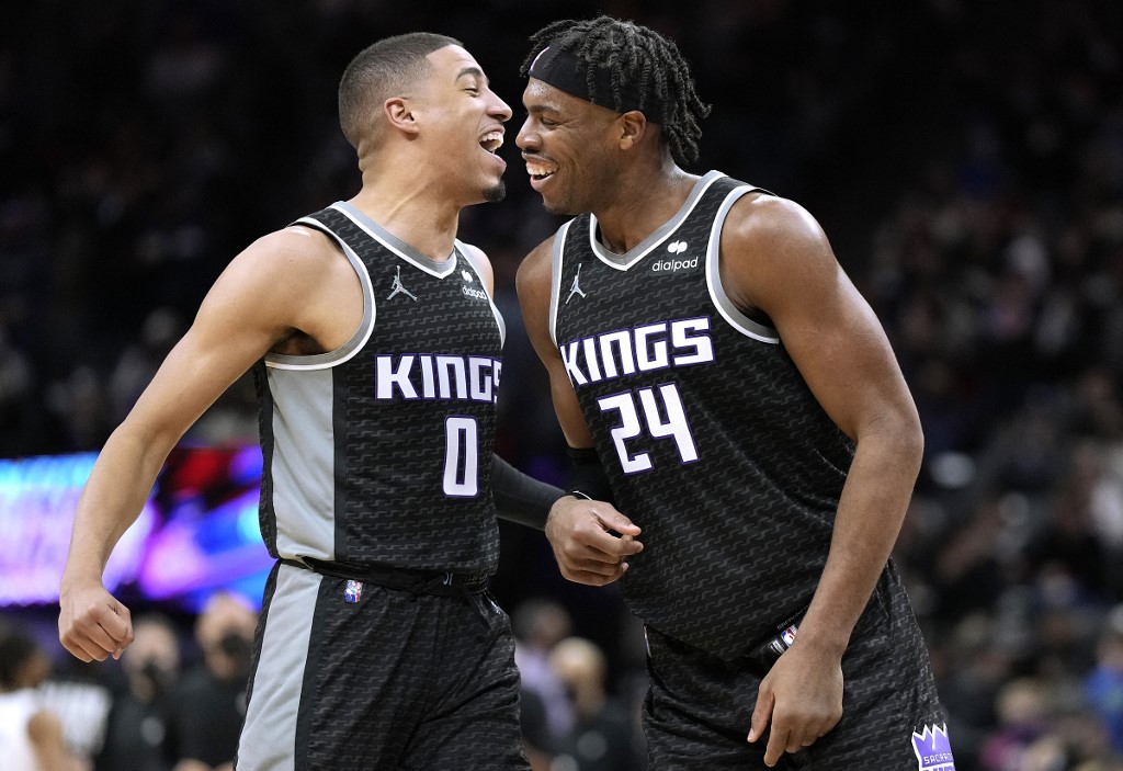Buddy Hield #24 and Tyrese Haliburton #0 of the Sacramento Kings reacts after Hill made a thee-point shot against the Brooklyn Nets during the second half of and NBA basketball game at Golden 1 Center on February 02, 2022 in Sacramento, California.