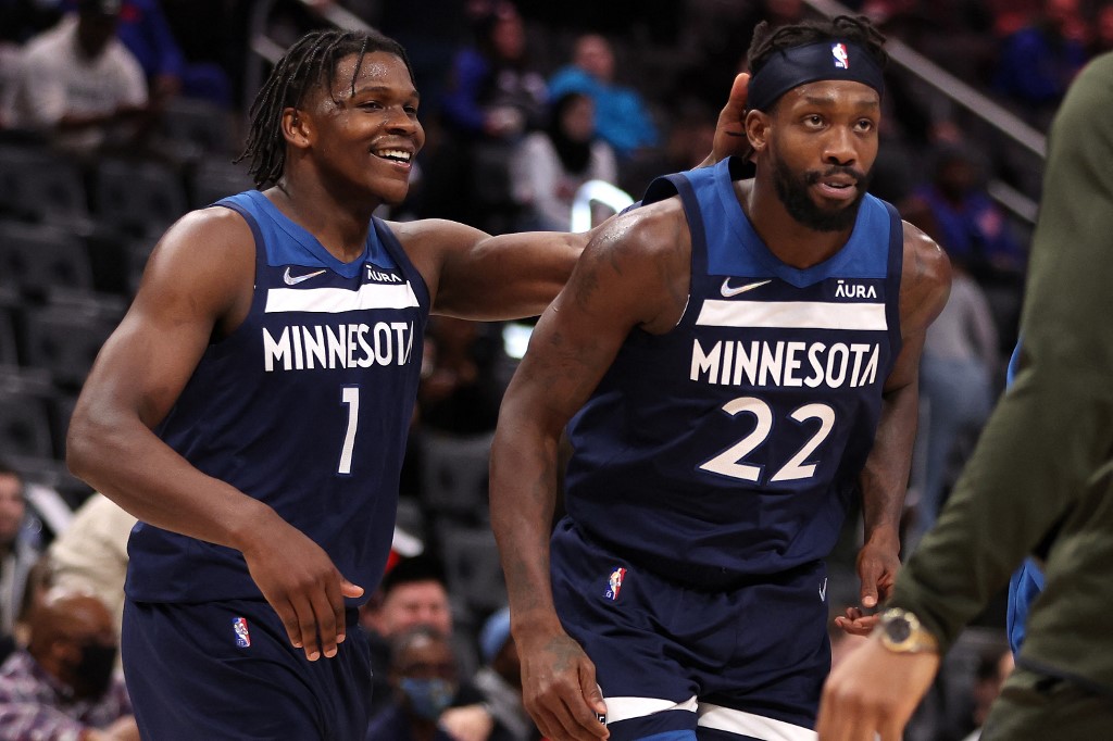 Patrick Beverley #22 of the Minnesota Timberwolves celebrates a late second half three pointer with Anthony Edwards #1 while playing the Detroit Pistons at Little Caesars Arena on February 03, 2022 in Detroit, Michigan