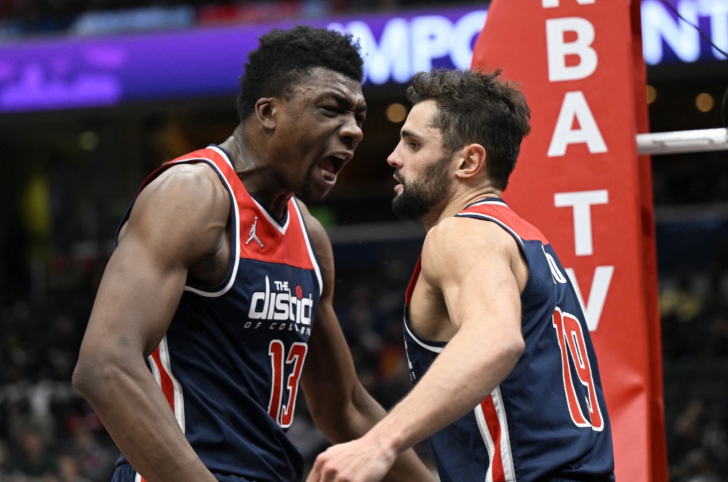 Thomas Bryant #13 and Raul Neto #19 of the Washington Wizards celebrate in the third quarter against the Brooklyn Nets at Capital One Arena on February 10, 2022 in Washington, DC. 