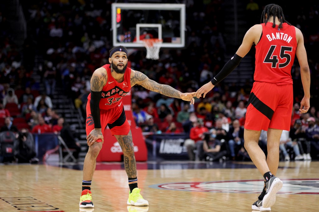 Gary Trent Jr. #33 high fives Dalano Banton #45 of the Toronto Raptors during the second half against the Houston Rocketsat Toyota Center on February 10, 2022 in 