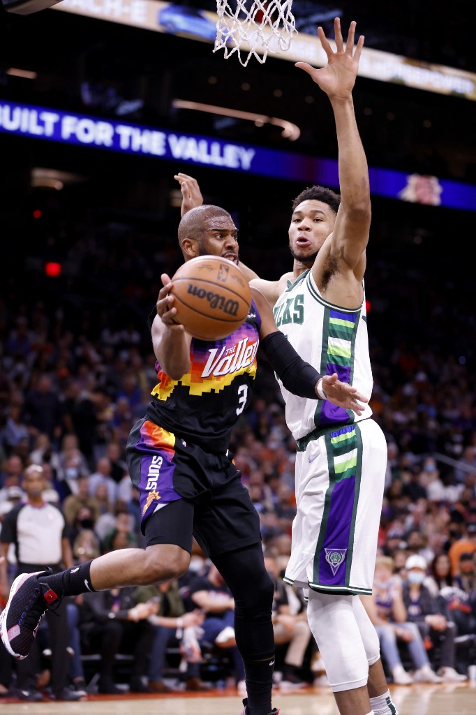 Giannis Antetokounmpo #34 of the Milwaukee Bucks defends Chris Paul #3 of the Phoenix Suns during the first half at Footprint Center on February 10, 2022 in Phoenix, Arizona. 