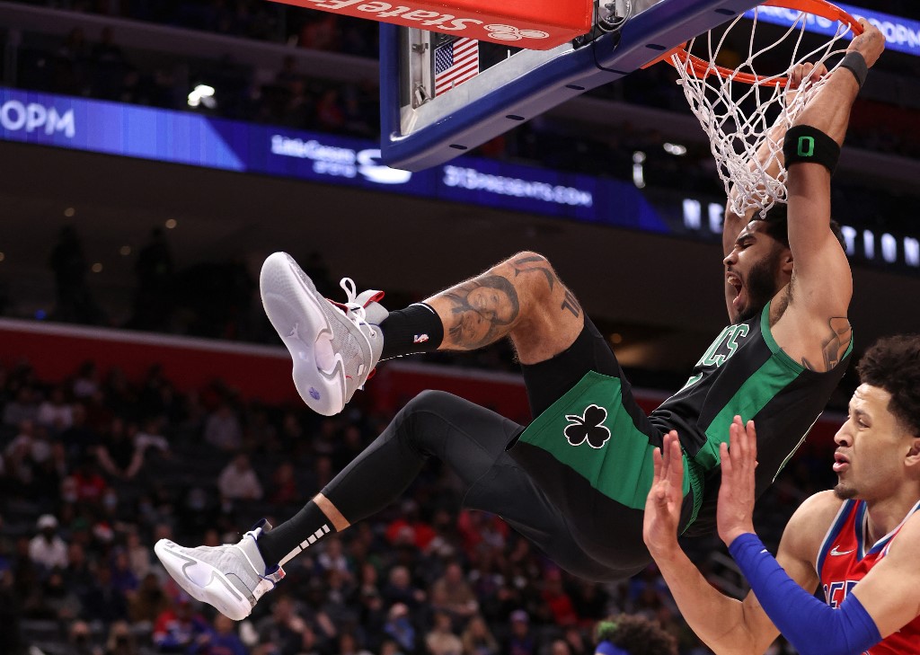 Jayson Tatum #0 of the Boston Celtics dunks in front of Cade Cunningham #2 of the Detroit Pistons during the second half at Little Caesars Arena on February 26, 2022 in Detroit, Michigan. Boston won the game 113-104, 