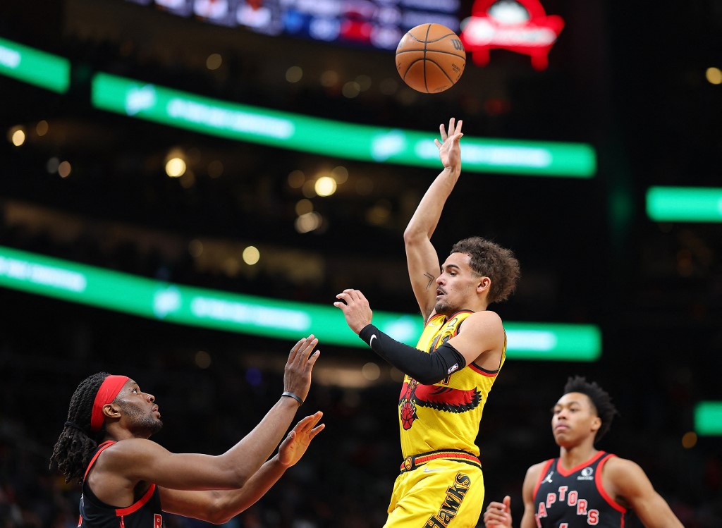 Trae Young #11 of the Atlanta Hawks shoots a basket against Precious Achiuwa #5 of the Toronto Raptors during the second half at State Farm Arena on February 26, 2022 in Atlanta, Georgia.