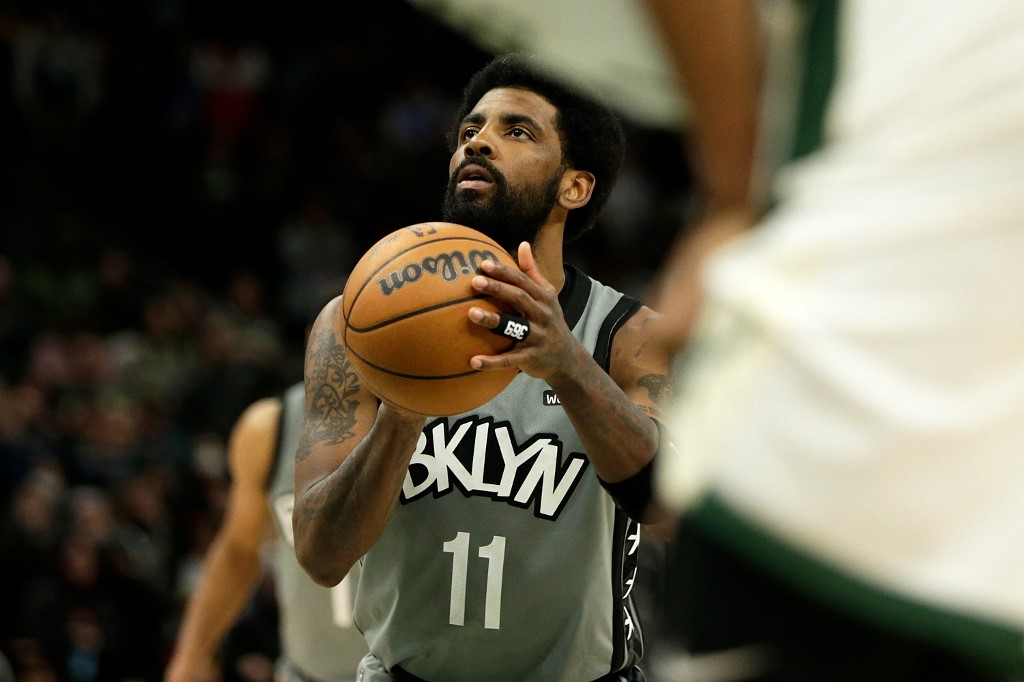 Kyrie Irving #11 of the Brooklyn Nets shoots a free throw late in the game against the Milwaukee Bucks at Fiserv Forum on February 26, 2022 in Milwaukee, Wisconsin