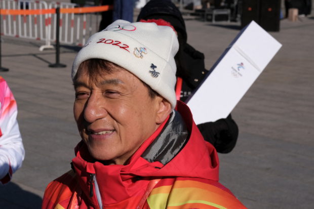 Olympics - Beijing 2022 Winter Olympics - Torch Relay - Beijing, China - February 3, 2022. Actor Jackie Chan talks to the media after taking part in the Torch Relay at the Badaling section of the Great Wall in Yanqing district. REUTERS/Ryan Woo