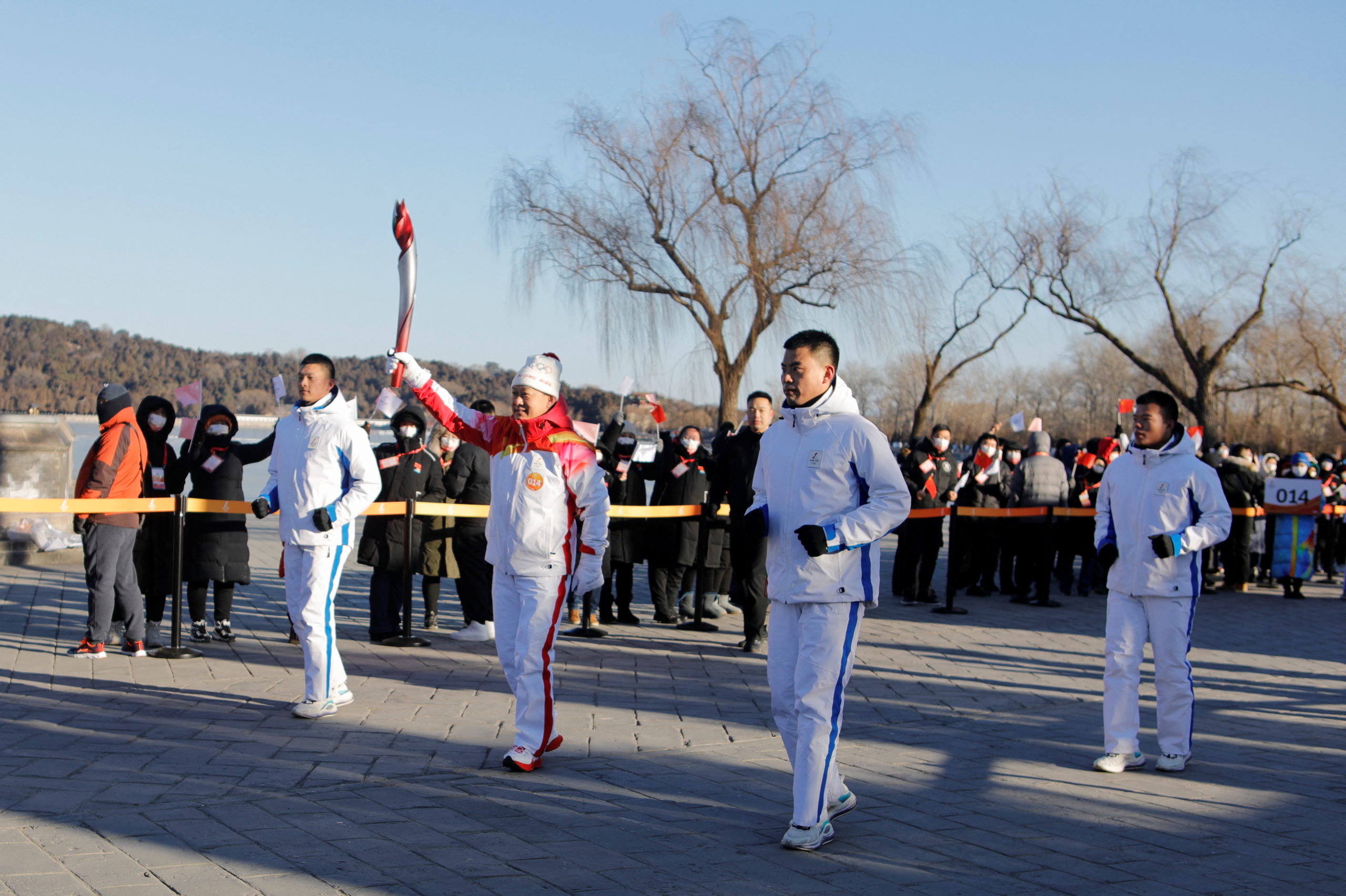 Olympics - Beijing 2022 Winter Olympics - Torch Relay - Beijing, China - February 4, 2022. Torch bearer Liu Qingquan carries the Olympic flame at the Summer Palace in Haidian district. 