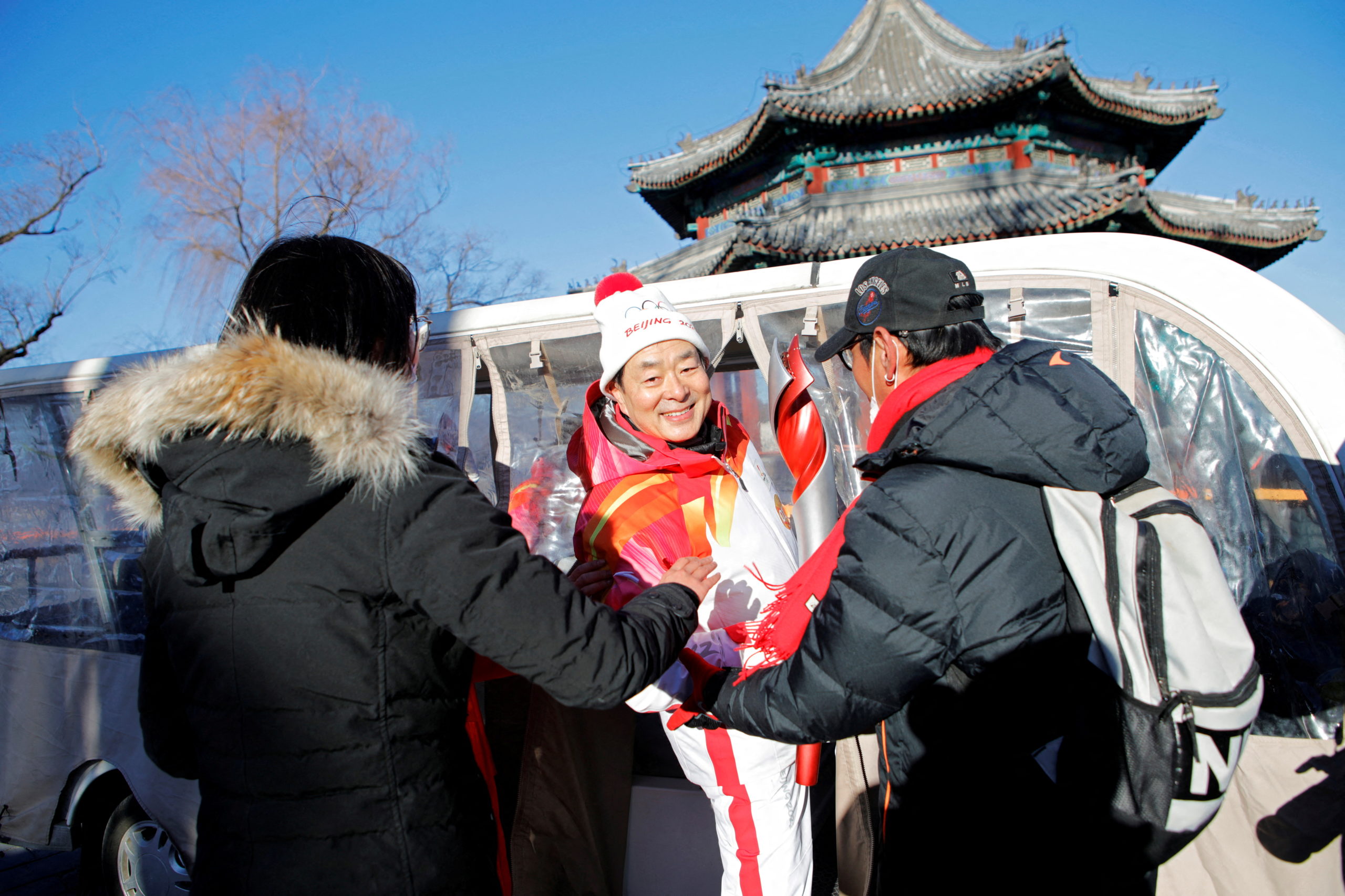 Olympics - Beijing 2022 Winter Olympics - Torch Relay - Beijing, China - February 4, 2022. Torchbearer Pu Cunxin boards a shuttle after his torch relay session at the Summer Palace in Haidian district. 