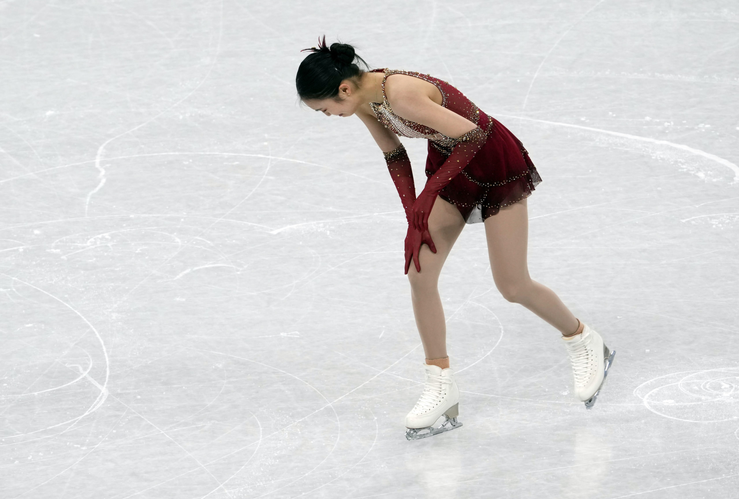 Feb 7, 2022; Beijing, China; Yi Zhu (CHN) reacts after performing in the women's single free skating portion of the figure skating mixed team final during the Beijing 2022 Olympic Winter Games at Capital Indoor Stadium. 