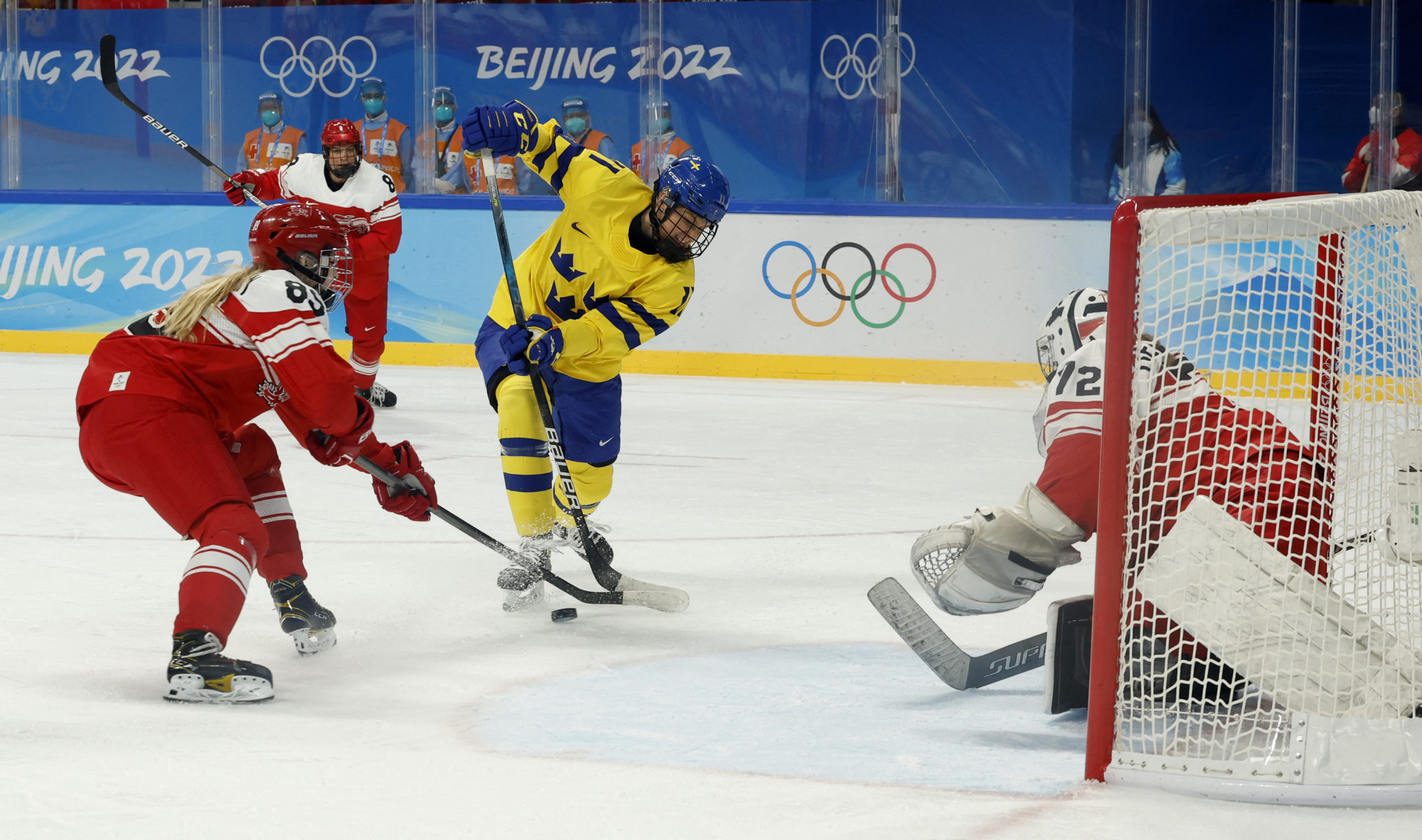 2022 Beijing Olympics - Ice Hockey - Women's Prelim. Round - Group B - Sweden v Denmark - Wukesong Sports Centre, Beijing, China - February 8, 2022. Josefin Bouveng of Sweden in action with Malene Frandsen of Denmark. 