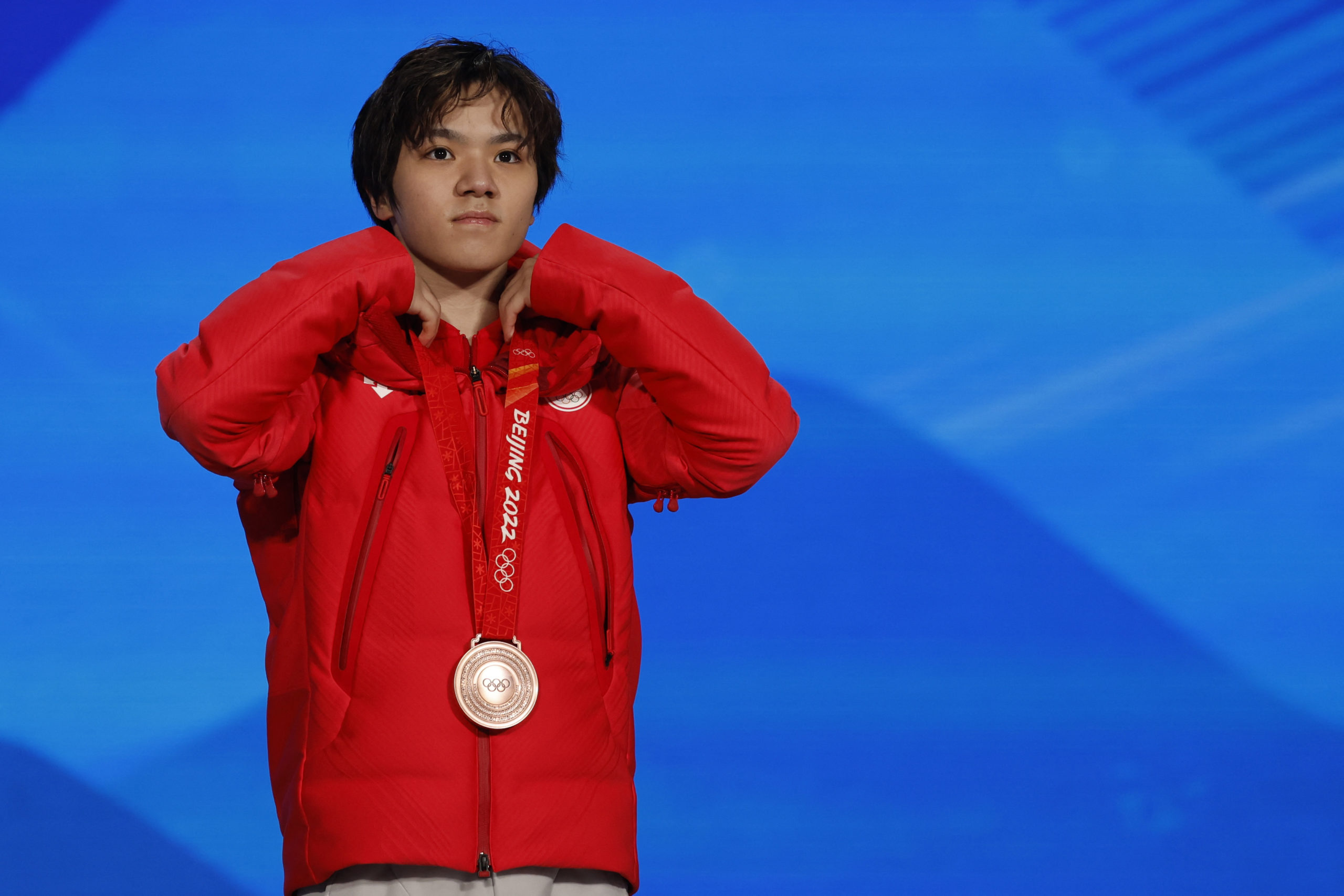 2022 Beijing Olympics - Victory Ceremony - Figure Skating Men's Single Skating - Beijing Medals Plaza, Beijing, China - February 10, 2022. Bronze medallist, Shoma Uno of Japan celebrates on the podium. 