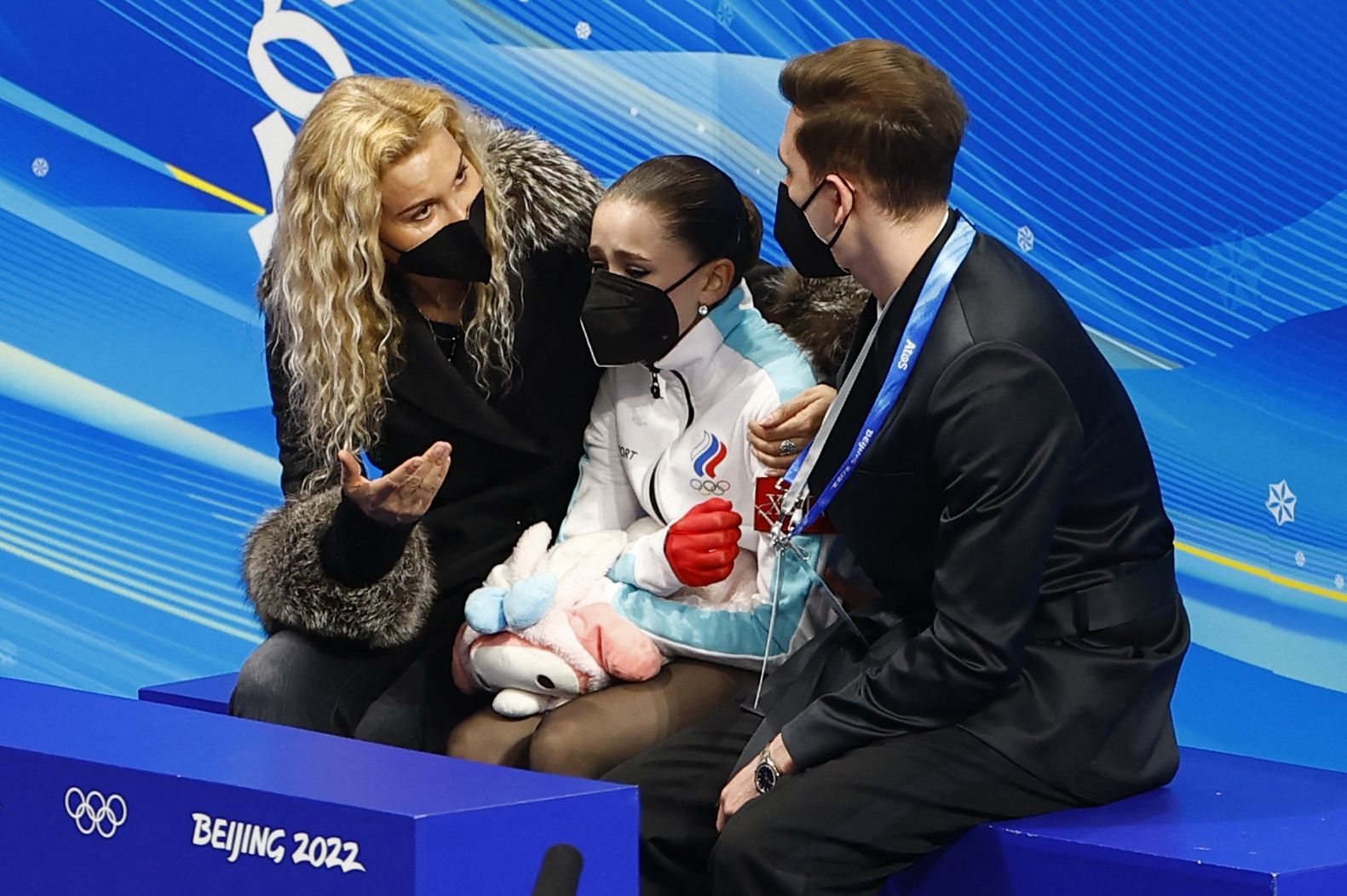 eijing, China - February 17, 2022. Kamila Valieva of the Russian Olympic Committee reacts with coaches Daniil Gleikhengauz and Eteri Tutberidze after her performance. 