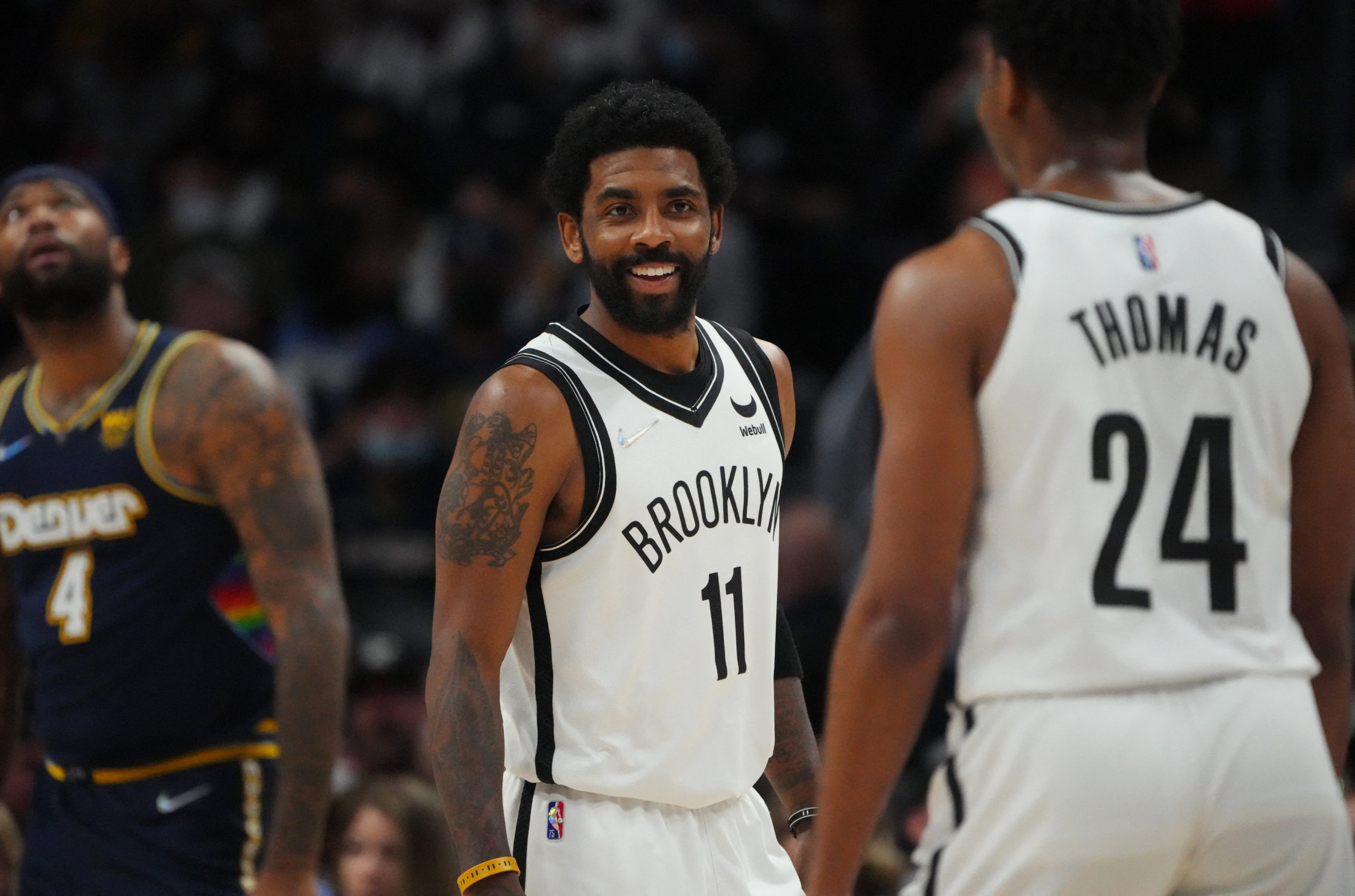 FILE PHOTO: Feb 6, 2022; Denver, Colorado, USA; Brooklyn Nets guard Kyrie Irving (11) reacts towards guard Cam Thomas (24) in the second quarter against the Denver Nuggets at Ball Arena. 