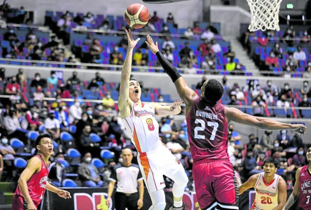 Robert Bolick (left) scores off Barangay Ginebra’s Sidney Onwubere in this file photo. 