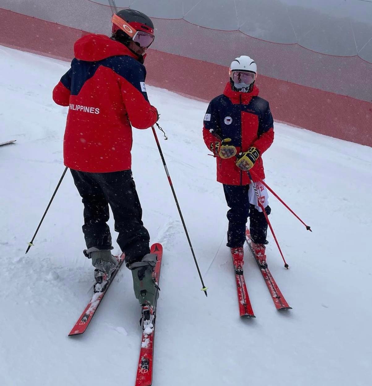 Coach Will Gregorak (left) and Asa Miller discussing their strategy prior to the men's slalom race.