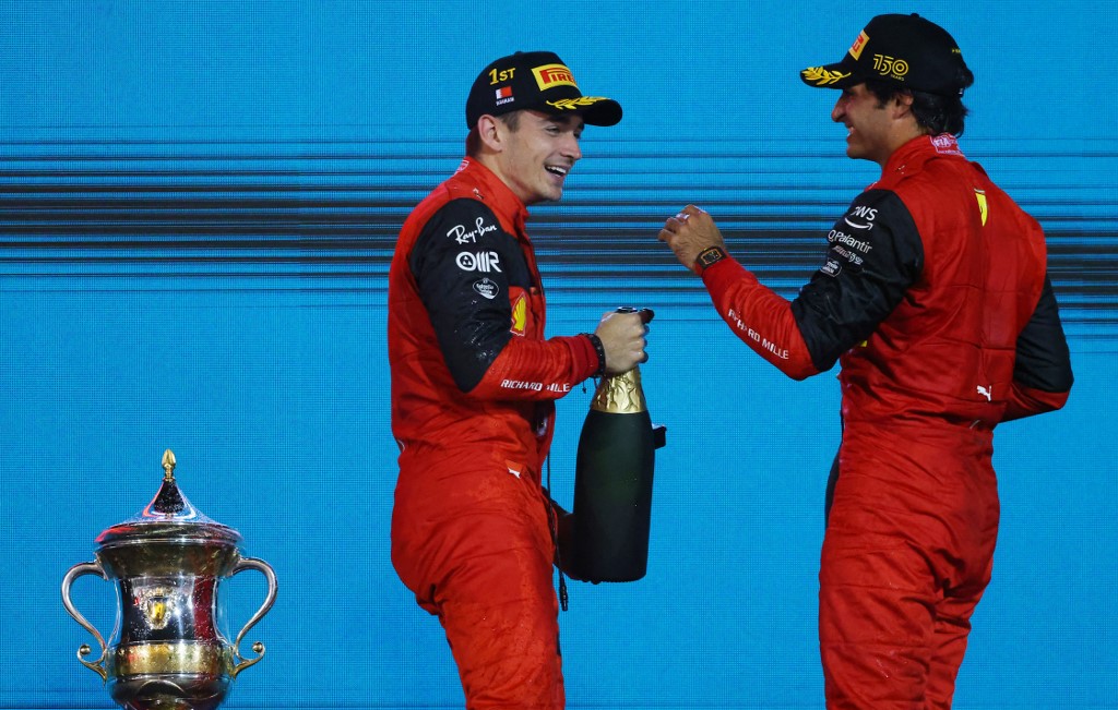 Winner Ferrari's Monegasque driver Charles Leclerc (L) and second place Ferrari's Spanish driver Carlos Sainz Jr celebrate on the podium winning the Bahrain Formula One Grand Prix at the Bahrain International Circuit in the city of Sakhir on March 20, 2022.