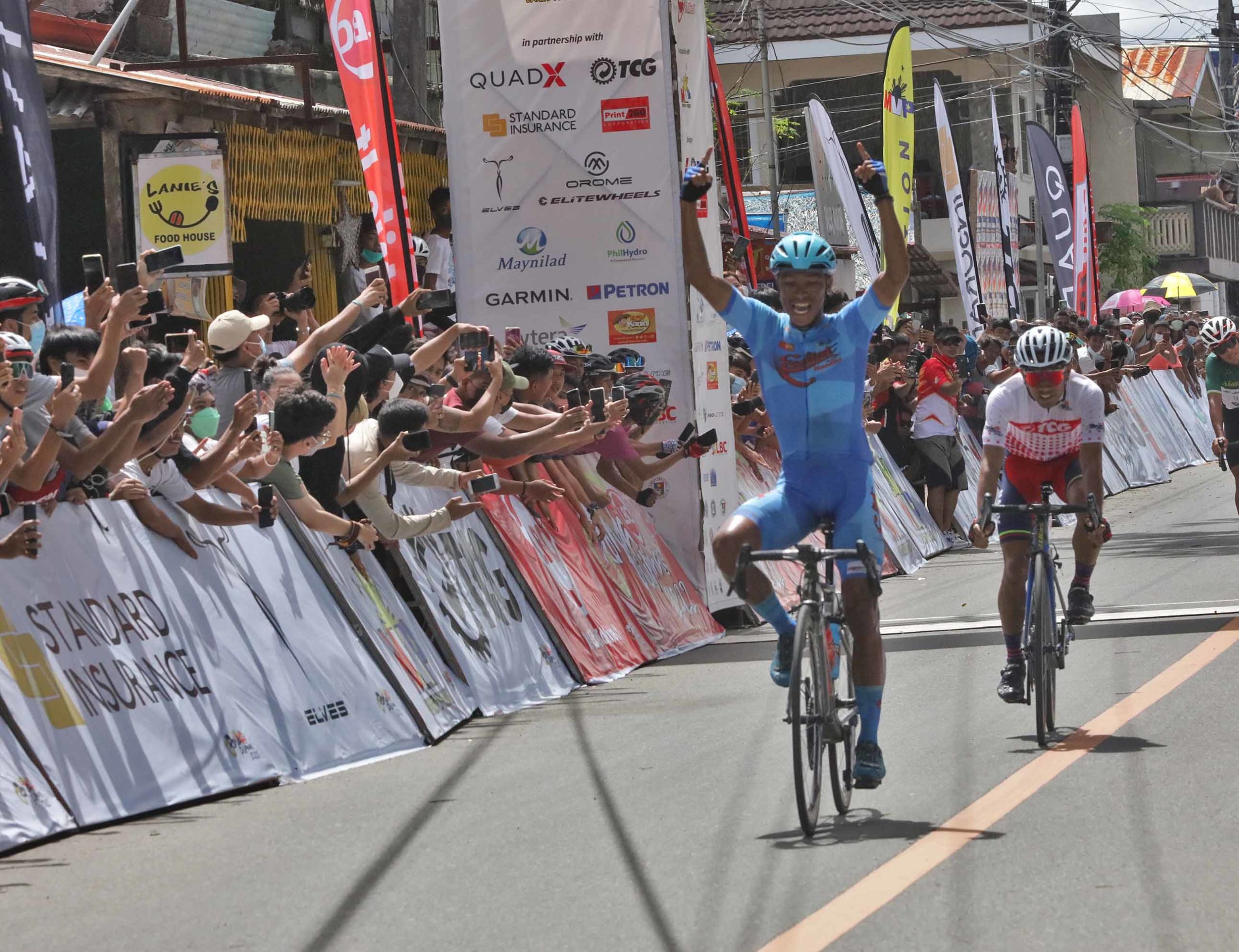 Ryan Tugawin of Excellent Noodles is first the cross the finish line in Stage Seven. 