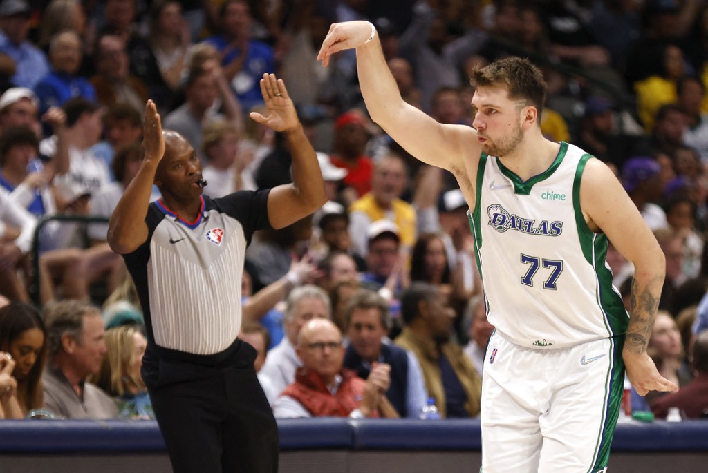 Luka Doncic #77 of the Dallas Mavericks celebrates a three point basket as referee Marc Davis #8 signals against the Los Angeles Lakers in the second half at American Airlines Center on March 29, 2022 in Dallas, Texas.