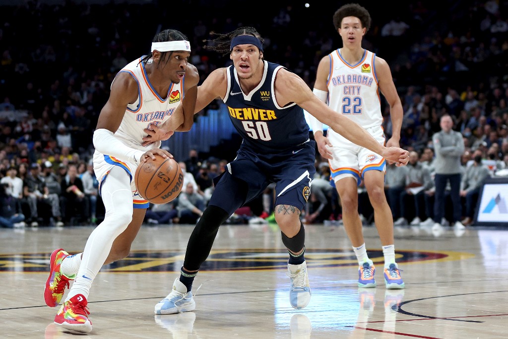 DENVER, COLORADO - MARCH 02: Shai Gilgeous-Alexander #2 of the Oklahoma City Thunder drives against Aaron Gordon #50 of the Denver Nuggets in the first quarter at Ball Arena on March 02, 2022 in Denver, Colorado. NOTE TO USER: User expressly acknowledges and agrees that, by downloading and or using this photograph, User is consenting to the terms and conditions of the Getty Images License Agreement. 