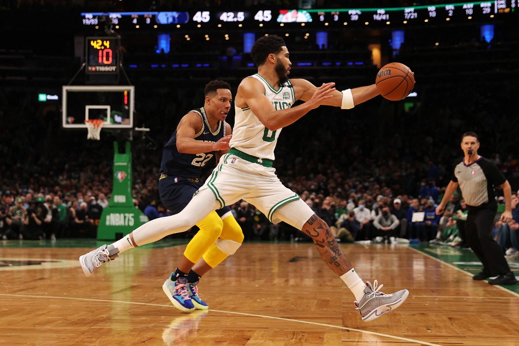 Jayson Tatum #0 of the Boston Celtics reaches for the ball as Desmond Bane #22 of the Memphis Grizzlies rushes to defend in the second quarter of the game at TD Garden on March 03, 2022 in Boston, Massachusetts.