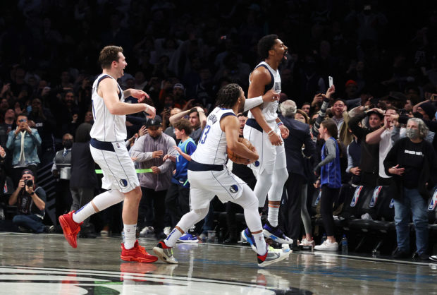 Spencer Dinwiddie #26 of the Dallas Mavericks celebrates after hitting a game winning shot with no time on the clock to defeat the Brooklyn Nets 113-11 during their game at Barclays Center on March 16, 2022 in New York City. NOTE T