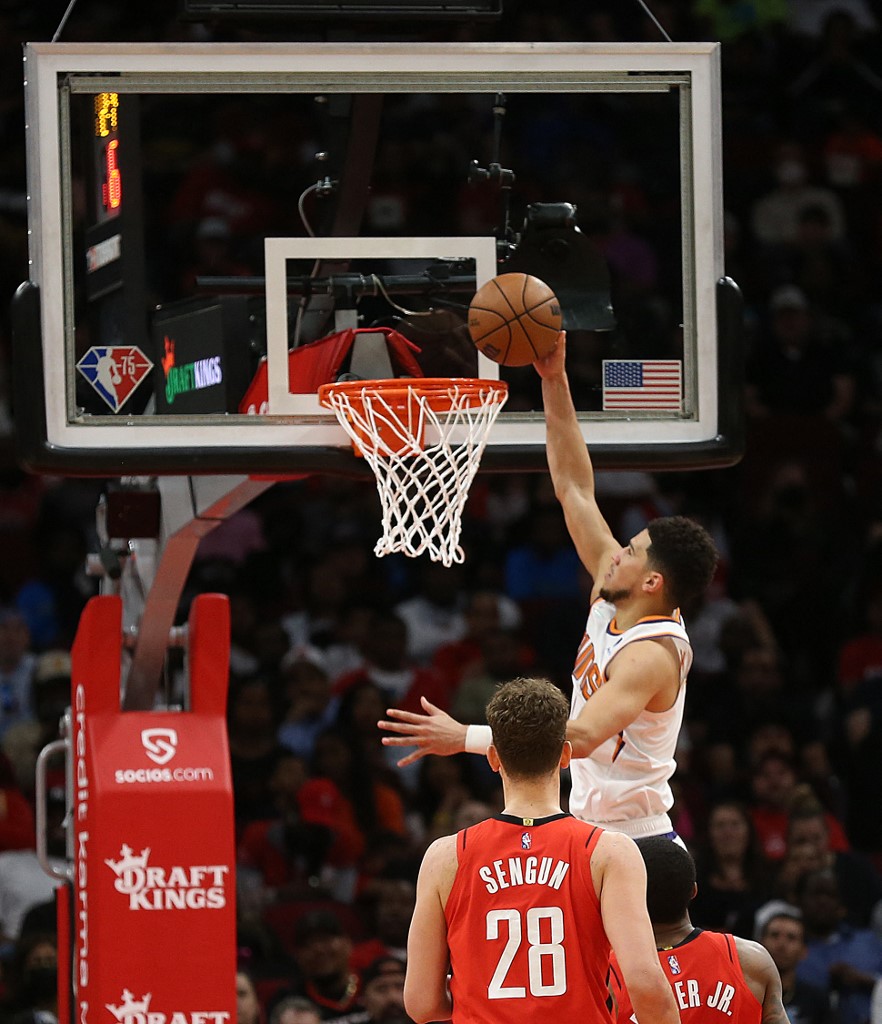 HOUSTON, TEXAS - MARCH 16: Devin Booker #1 of the Phoenix Suns dunks the ball on a fast break against the Houston Rockets during the fourth quarter at Toyota Center on March 16, 2022 in Houston, Texas. NOTE TO USER: User expressly acknowledges and agrees that, by downloading and or using this photograph, User is consenting to the terms and conditions of the Getty Images License Agreement. 