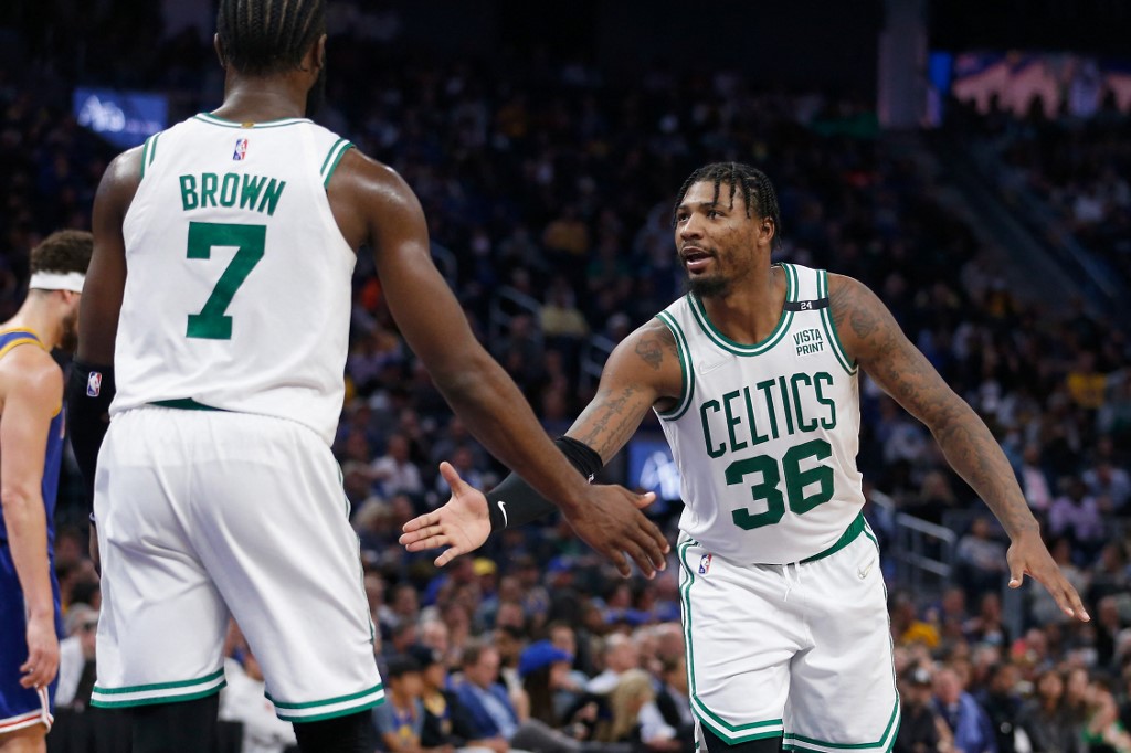 Marcus Smart #36 of the Boston Celtics celebrates with Jaylen Brown #7 after a basket in the fourth quarter against the Golden State Warriors at Chase Center on March 16, 2022 in San Francisco, California. 
