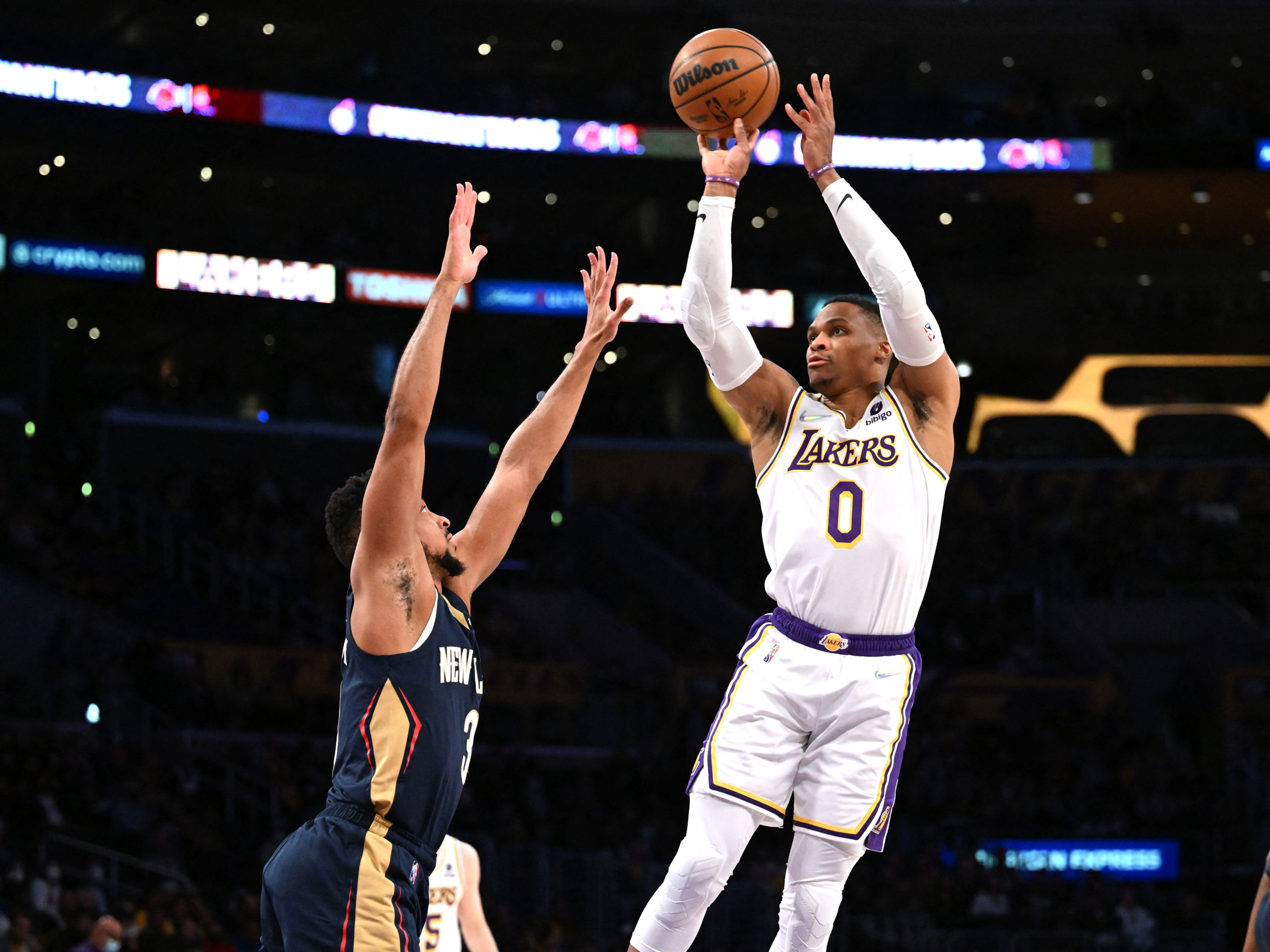 Feb 27, 2022; Los Angeles, California, USA; Los Angeles Lakers guard Russell Westbrook (0) is defended by New Orleans Pelicans guard CJ McCollum (3) as he shoots for a basket in the first half at Crypto.com Arena.